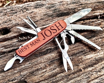 May include: A multi-tool pocket knife with a wooden handle engraved with "BEST MAN JOSH". The knife has a variety of tools, including a blade, a saw, a bottle opener, and a corkscrew.