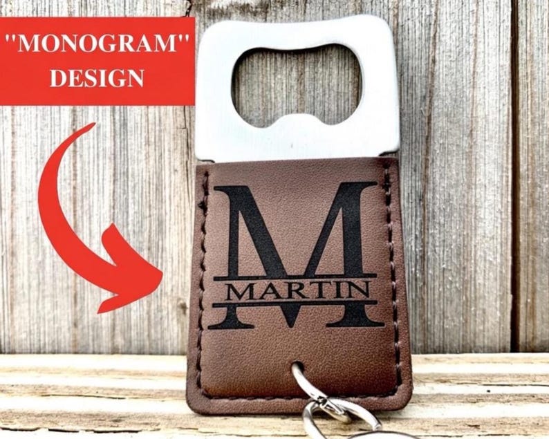 May include: A brown leather bottle opener with a silver metal opener. The leather portion features a black monogram "M" and the name "MARTIN" underneath. The words "MONOGRAM" and "DESIGN" are in a red rectangle.