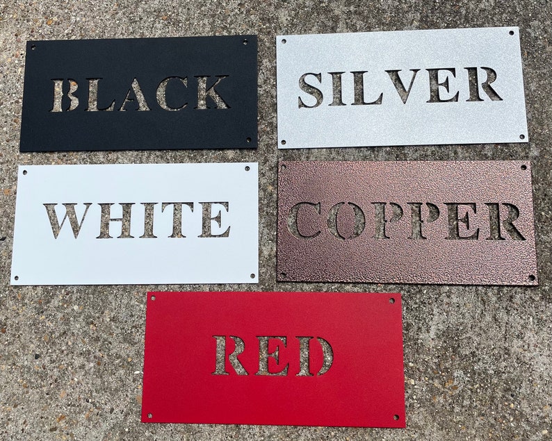 May include: Five metal signs with different colors and the words "BLACK", "SILVER", "WHITE", "COPPER", and "RED" cut out of the metal.