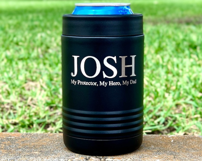 May include: Black insulated can cooler with the name "JOSH" and the text "My Protector, My Hero, My Dad" engraved in silver lettering.