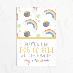 May include: A white card with a gold border and a rainbow pattern. The card says "You're the pot of gold at the end of my rainbow".