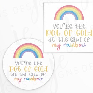 May include: Two white cards with rainbow graphics and the text "You're the Pot of Gold at the end of my rainbow." One card is square, the other is round. The rainbow is in pastel colors.