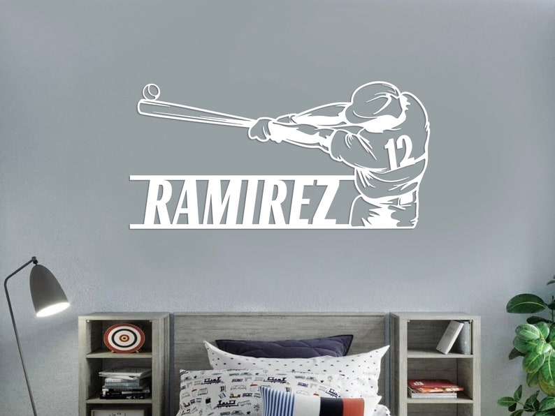 Pu&ograve; includere: Silhouette bianca di un giocatore di baseball che swinga una mazza con il nome "RAMIREZ" e il numero "12" sulla maglia.