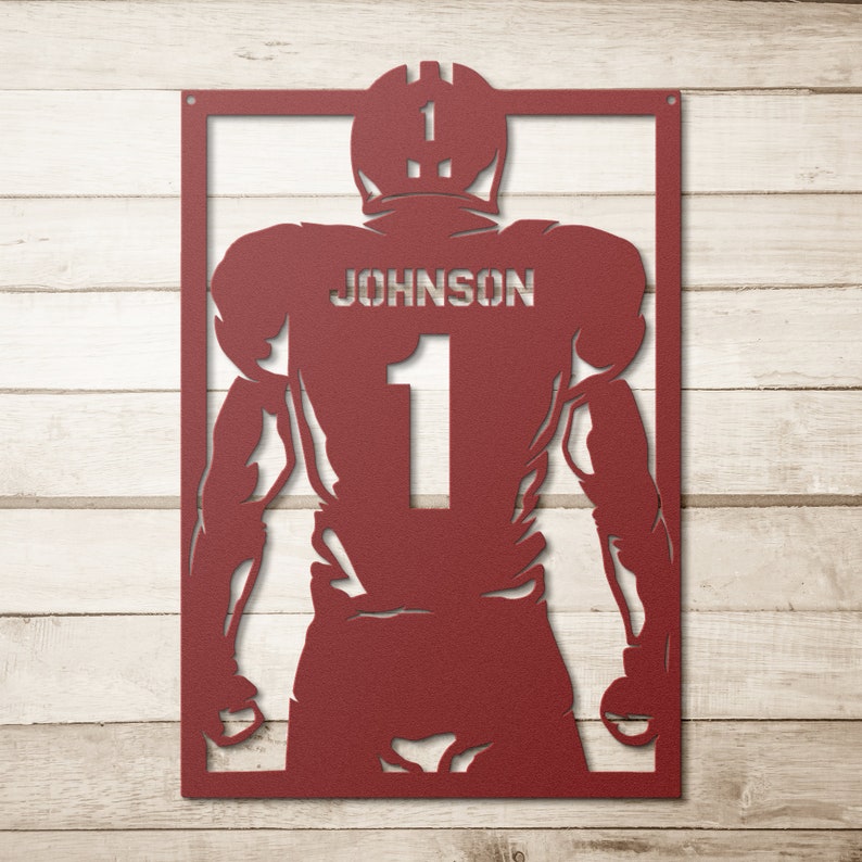 Pu&ograve; includere: Silhouette di un giocatore di football americano in metallo rosso con il nome "JOHNSON" e il numero "1" sul retro della maglia.