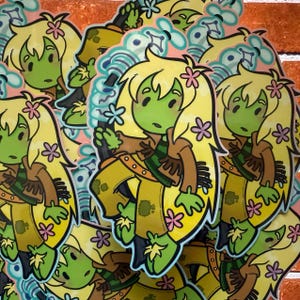 May include: A collection of stickers featuring a cartoon character with green skin, long yellow hair, and pink flower accents. The character wears a brown jacket, yellow pants, and a green and brown striped scarf. The stickers have a white border.