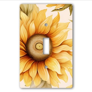 May include: A light switch cover featuring a close-up of a yellow sunflower with a brown center. The sunflower is painted in a watercolor style.