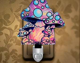 May include: A colorful mushroom-shaped night light with a psychedelic design. The mushroom features a swirling pattern of pink, purple, and yellow, with blue and white polka dots. The night light plugs directly into a wall outlet.