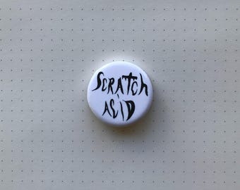 Badge scratch acide