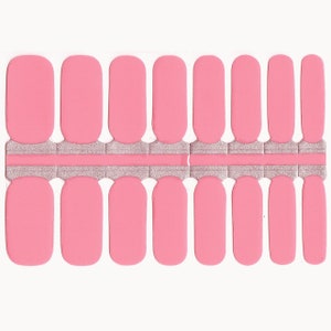 May include: A sheet of pink nail polish wraps with a silver glitter accent strip. The nail wraps are designed to be applied to fingernails.