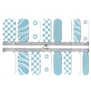 May include: A set of 10 blue and white nail wraps featuring checkered, wavy, and floral designs. The nail wraps are designed to be used with a nail polish base.