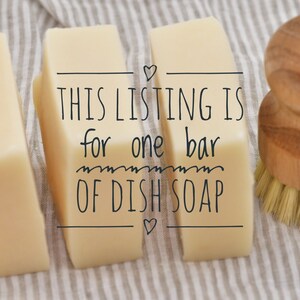 May include: Image of three rectangular bars of dish soap with a wooden handled brush. The text on the soap reads: "THIS LISTING IS for one bar OF DISH SOAP". The soap is light yellow and the brush has light brown bristles.