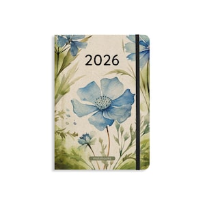 May include: A 2026 diary with a watercolour floral design. The cover displays a large blue flower with a detailed centre, surrounded by green leaves and smaller blue flowers. The year "2026" is printed in black.