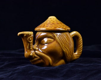 Vintage teapot of glazed stoneware in mustard and brown; ceramic pitcher shaped like a head of a highlander with a pipe; handmade pottery