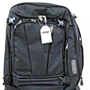 May include: Black travel backpack with multiple pockets and adjustable straps. The backpack has a tag that says "eBags".