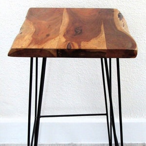 May include: A wooden side table with a live edge top and black hairpin legs.