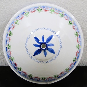 May include: White ceramic bowl with a blue and white floral design. The bowl has a pink and green floral border around the rim.