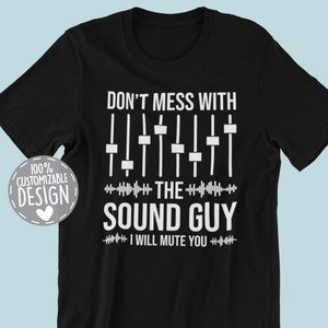 May include: Black t-shirt with white text that reads "Don't mess with the sound guy I will mute you." The text is accompanied by a graphic of a soundboard with sliders.