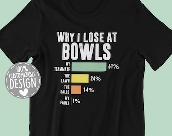May include: Black t-shirt with a white graphic that says "Why I Lose at Bowls" and a bar graph showing the percentage of blame for losing at bowling. The bar graph shows that 61% of the blame is on the teammate, 24% is on the lawn, 14% is on the balls, and 1% is on the person wearing the shirt.