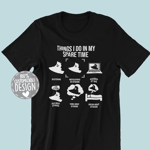 May include: Black t-shirt with a white graphic that says "Things I do in my spare time" and shows a series of illustrations of a person jet skiing, watching others jet ski, researching jet skis, talking about jet skiing, thinking about jet skiing, and dreaming about jet skiing.