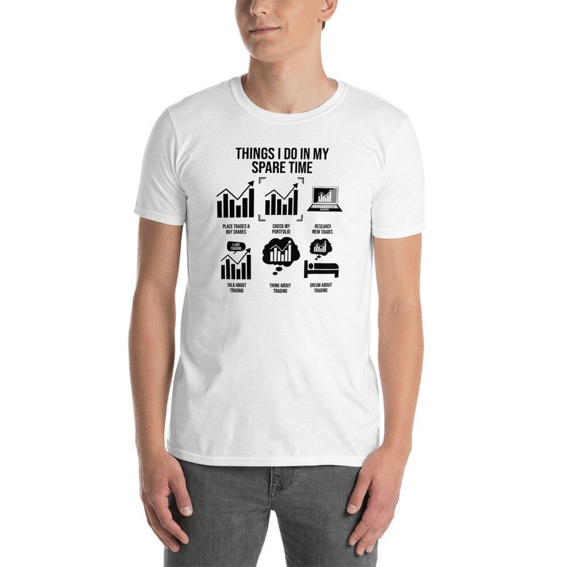 May include: White t-shirt featuring a black graphic that reads "Things I do in my spare time" and depicts a sequence of charts and icons associated with trading.