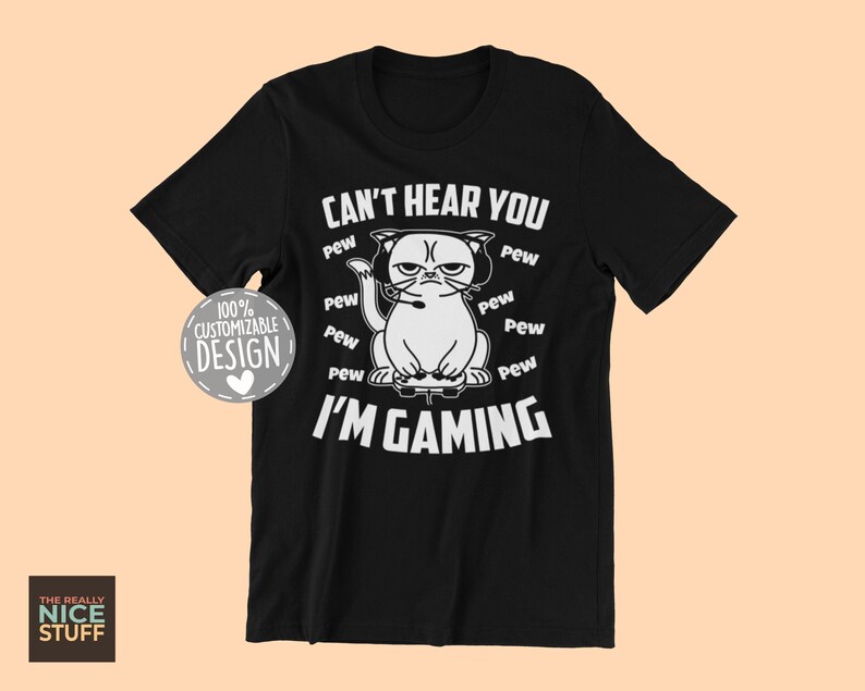 May include: Black t-shirt with a white graphic of a cat wearing headphones and holding a video game controller. The text "Can't hear you I'm gaming" is printed on the shirt with the word "pew" repeated around the cat graphic.