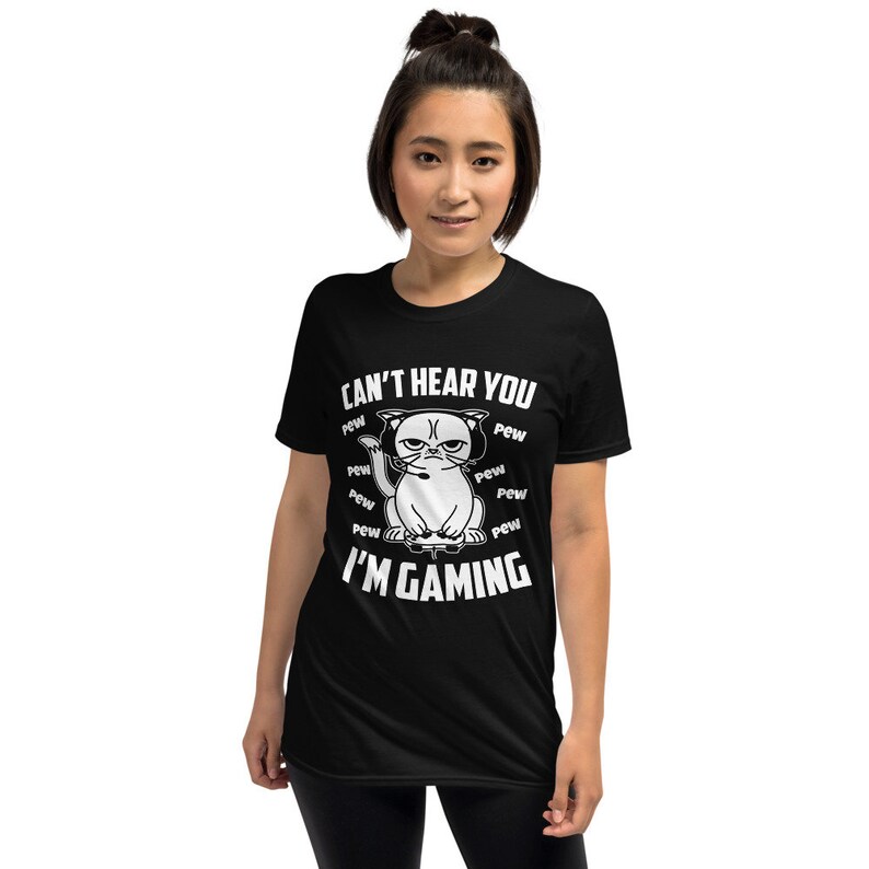 May include: Black t-shirt with a white graphic of a cat wearing headphones and holding a video game controller. The text "Can't hear you I'm gaming" is printed on the shirt.