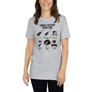 May include: A gray t-shirt with the text "Things I do in my spare time" and a list of activities related to playing the cello. The activities include playing cello, watching others play cello, researching cellos, talking about cellos, thinking about cellos, and dreaming about cellos.