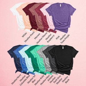 May include: A variety of t-shirt colors, including white, heather peach, maroon, heather mauve, heather raspberry, pink, heather team purple, heather navy, heather columbia blue, heather ice, blue, heather kelly, heather mint, athletic heather, dark grey, heather, and black.
