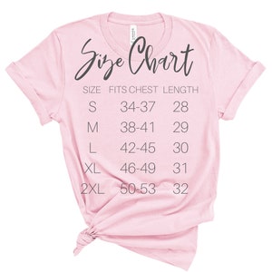 May include: A pink t-shirt with a size chart printed on the front. The chart shows the size, chest measurement in inches, and length in inches.  Sizes include S, M, L, XL, and 2XL.