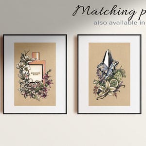Pu&ograve; includere: Due stampe incorniciate di flaconi di profumo con illustrazioni floreali. La stampa a sinistra presenta una bottiglia Gucci Bloom rosa con fiori bianchi. La stampa a destra presenta una bottiglia argentata con un tappo a forma di stella e fiori bianchi.
