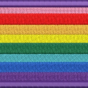 May include: A colourful embroidered patch with a rainbow design. The patch has seven stripes in the colours of the rainbow: pink, red, orange, yellow, green, blue, and purple. The patch is surrounded by a purple border.