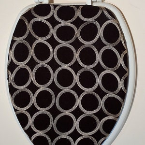 Designer Toilet Seat Cover : Bathroom Decorating ideas. Beautiful fabric. Black with gold rings.