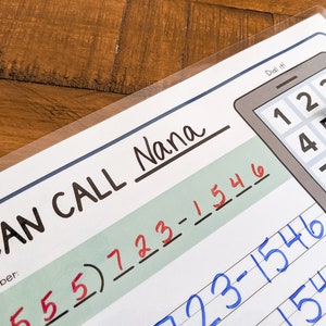 May include: A printable worksheet for kids to practice phone number recognition and writing. The worksheet features a phone with a dial pad and a space to write the phone number "555)723-1546" for "Nana".