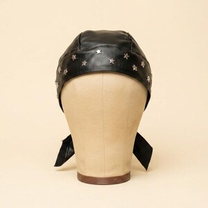 May include: A black head covering featuring a textured surface and a row of small, silver-toned metal star-shaped studs arranged along the front edge. The head covering includes two fabric ties extending from the sides for securing the item.