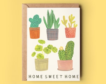 May include: A greeting card with a white background and the text "HOME SWEET HOME" at the bottom. The card features six potted plants, including a cactus, a succulent, and a fern, all drawn in a colorful, cartoon style.