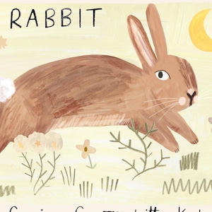 May include: A whimsical illustration of a brown rabbit with long ears, set against a light yellow background. The word "RABBIT" is written in black at the top. The artwork includes stylized plants and a crescent moon, creating a charming, nature-inspired scene.