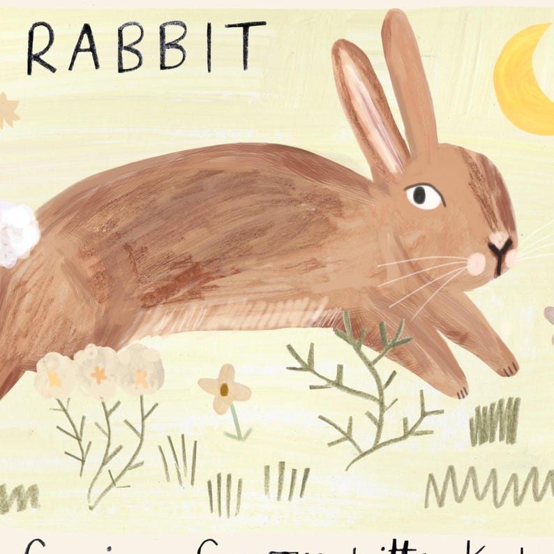 May include: A whimsical illustration of a brown rabbit with long ears, set against a light yellow background. The word "RABBIT" is written in black at the top. The artwork includes stylized plants and a crescent moon, creating a charming, nature-inspired scene.