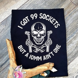 May include: Black t-shirt with a white skull graphic and the text "I got 99 sockets but a 10mm ain't one".