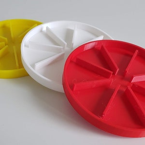 May include: Three round, divided serving dishes in yellow, white, and red. Each dish has eight sections.