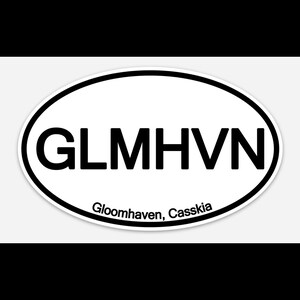 May include: Oval sticker with the text "GLMHVN" in bold, black letters. Below the main text is the text "Gloomhaven, Casskia" in a smaller font. The sticker has a white background with a black border.