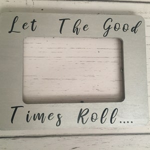 May include: A silver picture frame with the text "Let The Good Times Roll..." in black lettering.