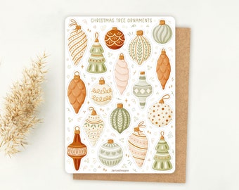 Puede incluir: Una hoja de pegatinas titulada CHRISTMAS TREE ORNAMENTS que presenta varias ilustraciones de adornos navideños en tonos verde salvia, terracota, crema y rosa suave. Los diseños incluyen formas de piña, lágrima y redondas con patrones.