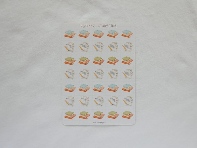 May include: A sticker sheet with the text "PLANNER - STUDY TIME" at the top. The sheet features small illustrations of stacks of books, pencils, and papers. The books are in shades of orange, green, and blue. The illustrations are in a watercolor style.