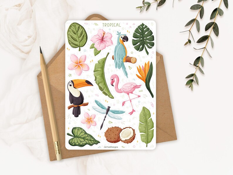 May include: A rectangular sticker sheet labelled TROPICAL featuring illustrations of a toucan, a flamingo, a blue parrot, a dragonfly, a coconut, and various tropical flowers and green leaves. The sheet includes small geometric shapes and text.