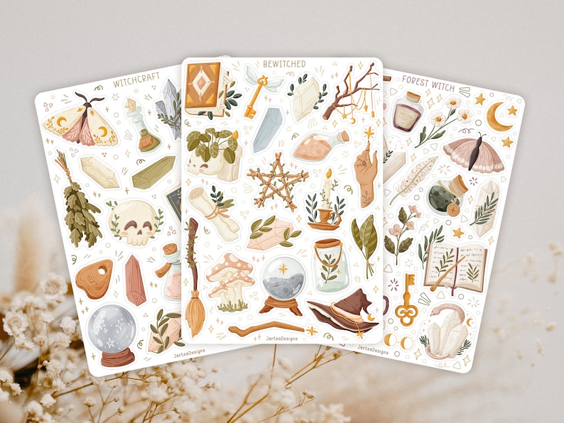 May include: Three sticker sheets featuring illustrations of crystals, moths, skulls, mushrooms, potion bottles, books, keys, and wands. The sheets are labelled Witchcraft, Bewitched, and Forest Witch, with JartesDesigns printed at the bottom.