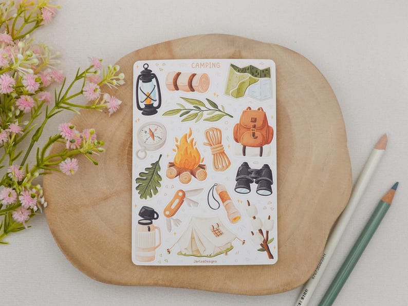 May include: A rectangular sticker sheet titled CAMPING featuring various illustrations including a lantern, rolled sleeping bag, map, compass, campfire, rope, backpack, binoculars, oak leaf, pocket knife, flashlight, tent, and thermos.