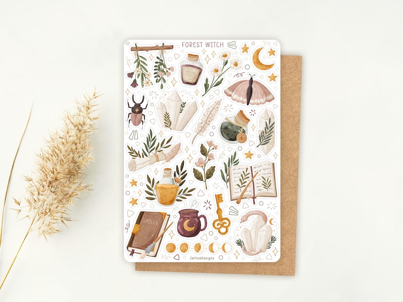 May include: A sticker sheet titled Forest Witch featuring illustrations of crystals, a moth, a beetle, a spellbook, a potion bottle, a key, a mug with a moon, flowers, and moon phases. The sheet includes various small star and geometric shapes.