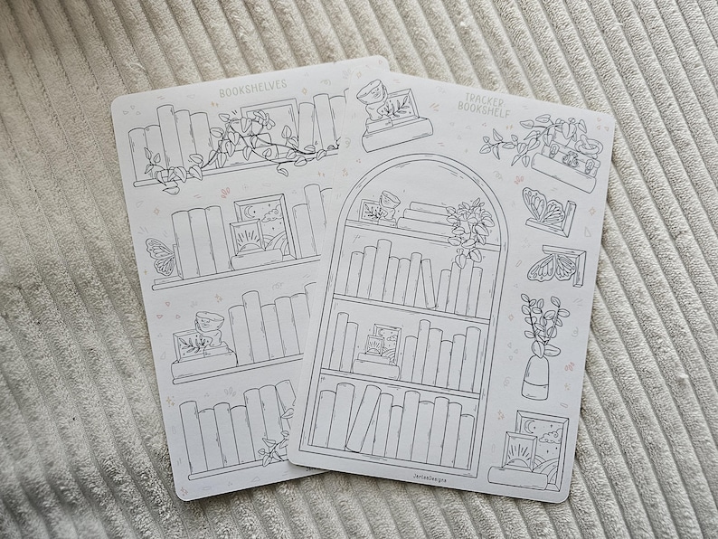 May include: Two white sticker sheets with bookshelf and botanical illustrations. One sheet reads "Bookshelves" and the other reads "Tracker Bookshelf". The designs include books, plants, butterflies, and framed art, all in a line drawing style.