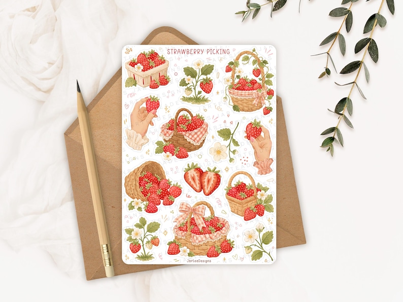 May include: A sticker sheet titled STRAWBERRY PICKING featuring various illustrations of red strawberries, woven baskets filled with fruit, strawberry plants with white flowers, and hands holding strawberries, all rendered in a soft watercolor style.