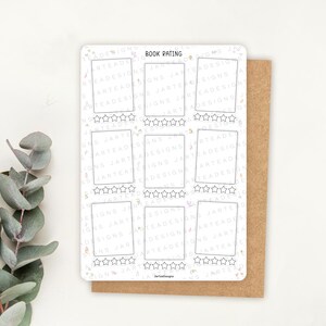 May include: A white book rating sticker with the words "BOOK RATING" at the top. The sticker has ten rectangular boxes with star ratings below each box. The sticker is on a brown card.